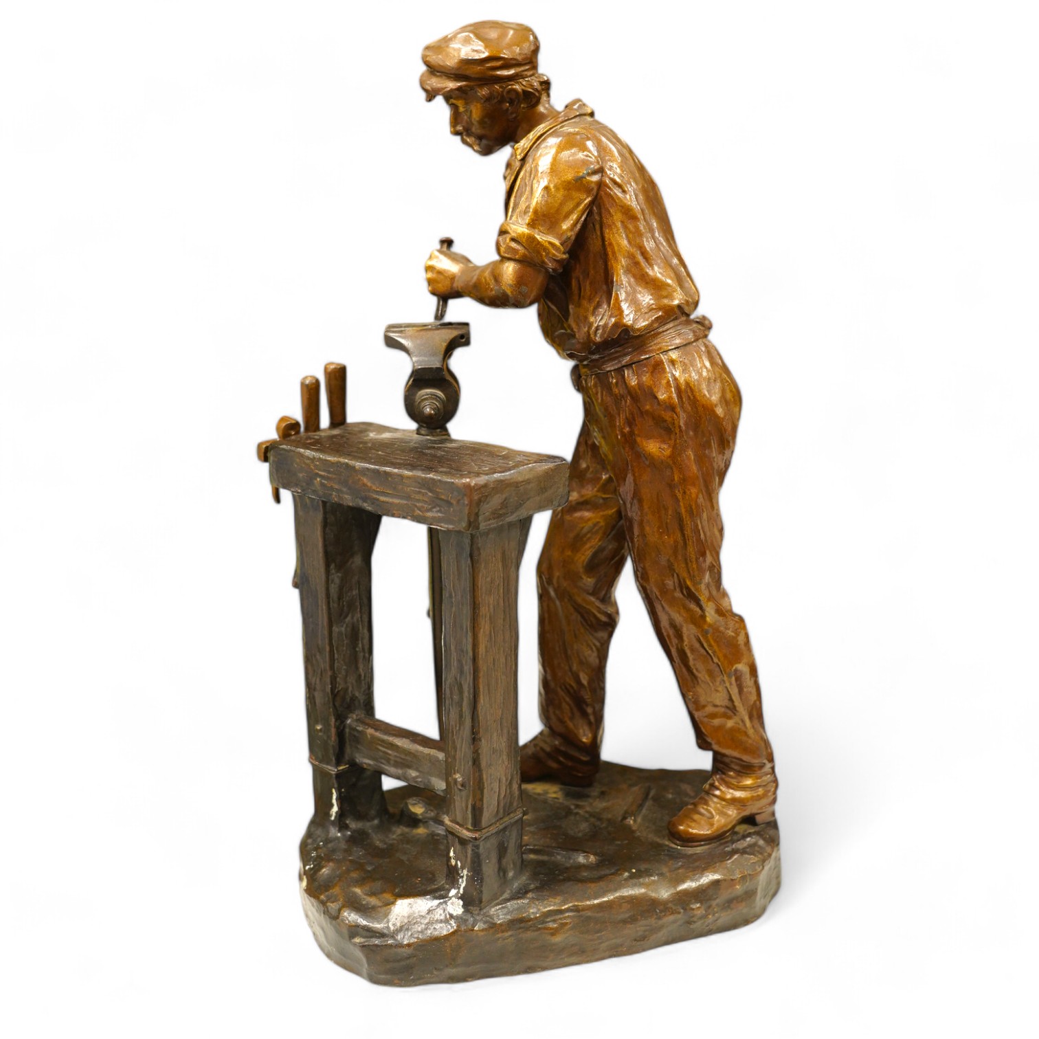 A large bronze of a blacksmith and work bench, signed Carlier, 42cm high. Condition - good